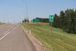 sign on highway 54 where you turn left  for garlic goodness growing natural garlic, seasonal vegetables and raising sustainable highland beef in red deer county ab